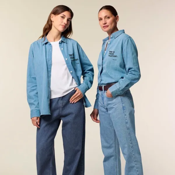 Women wear denim blue shirt which says be a nice human